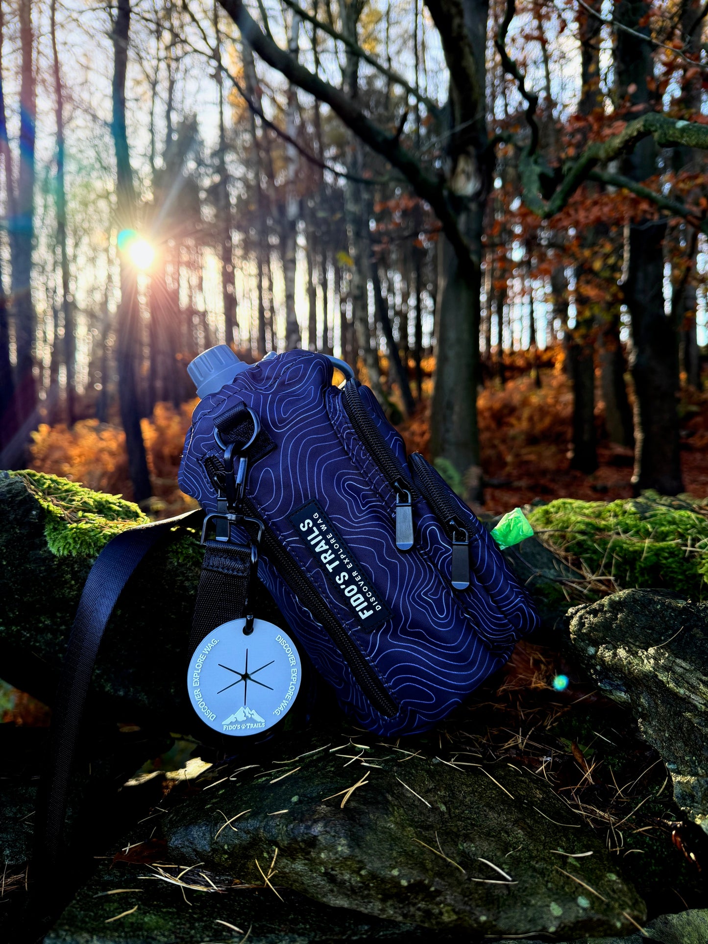 Black Contour Trail Bottle Bag placed outdoors during woodland walk