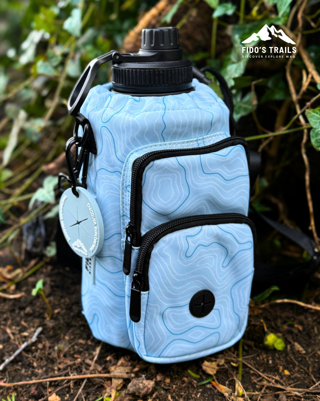 Coastal Blue Contour Trail Bottle Bag placed outdoors during walk