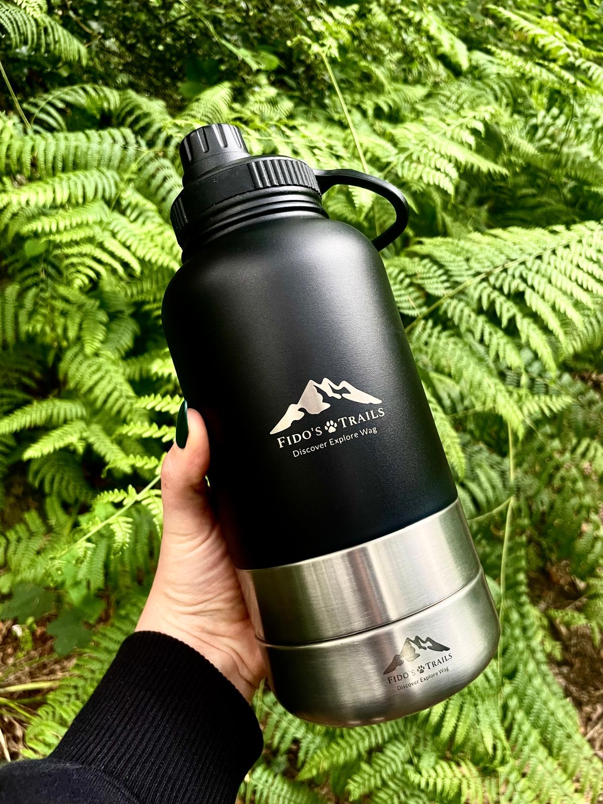 Portable 3-in-1 dog water bottle in Black used outdoors during a woodland walk