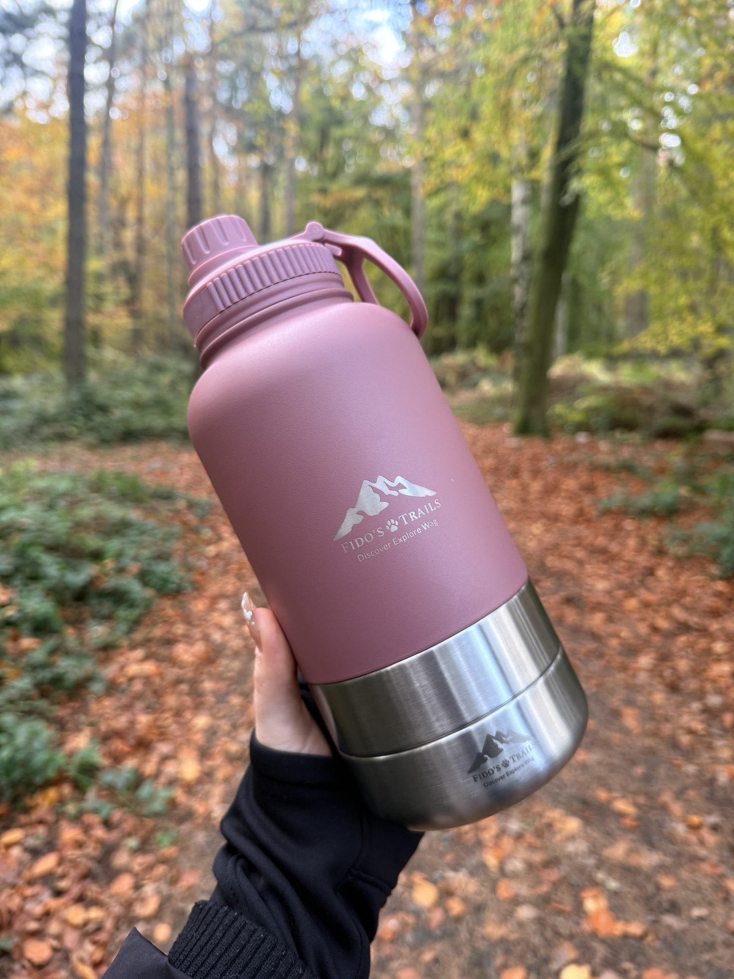 Portable 3-in-1 dog water bottle in Rosewood used outdoors during a woodland walk