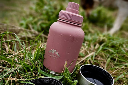 Rosewood 3-in-1 dog water bottle placed in grass during outdoor walk