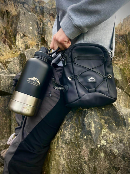 Dog owner wearing tactical dog walking bag outdoors on adventure
